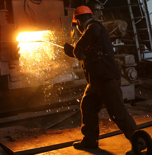 Foundry technician working at a furnace