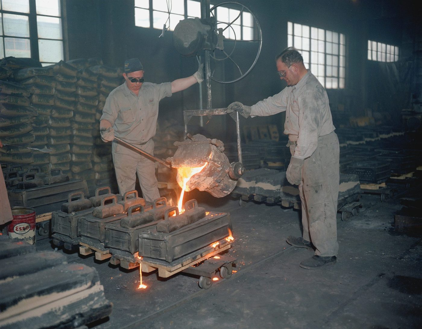 Foundry workers handling hot metal